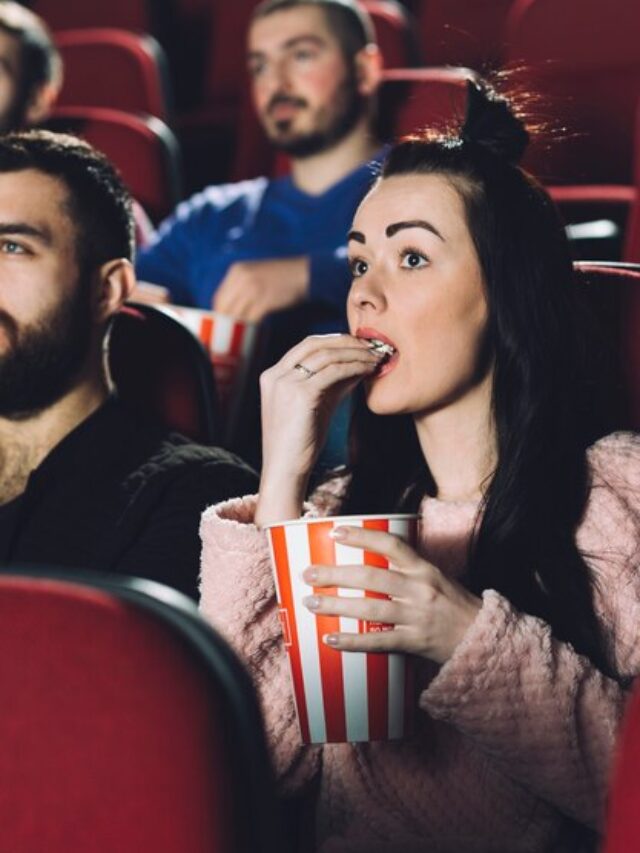 beautiful-woman-eating-popcorn-cinema_23-2147803798