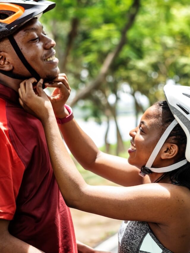 woman-fastens-bike-helmet-her-boyfriend_53876-41093