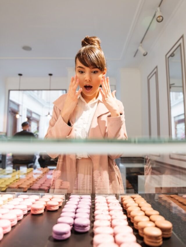 woman-standing-front-glass-showcase-with-pastries_171337-16936