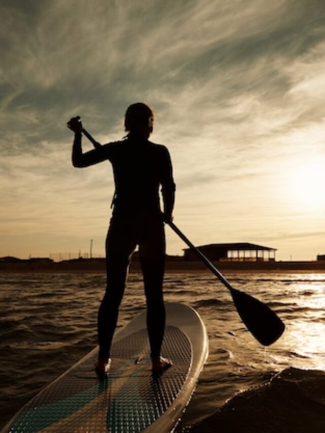 young-blonde-female-paddleboard-sea_273609-15075